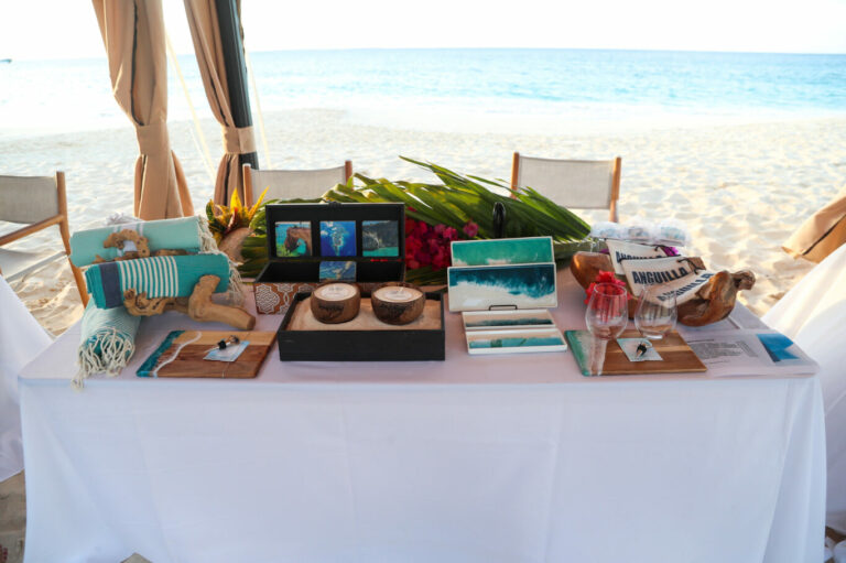 Table set up on a beach with gifts for travel program attendees