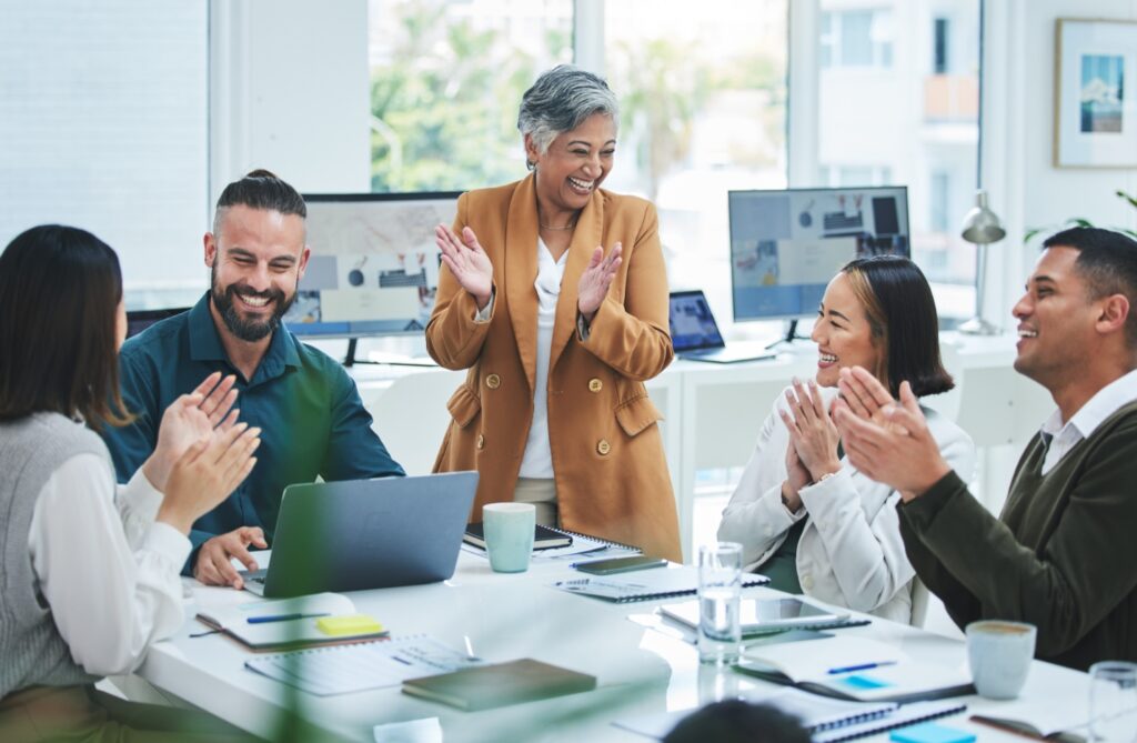 Team clapping at meeting