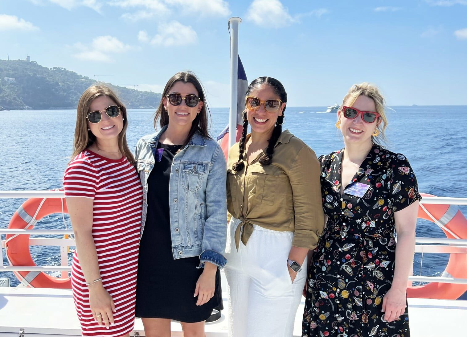 Brightspot employees smiling for group photo on a boat