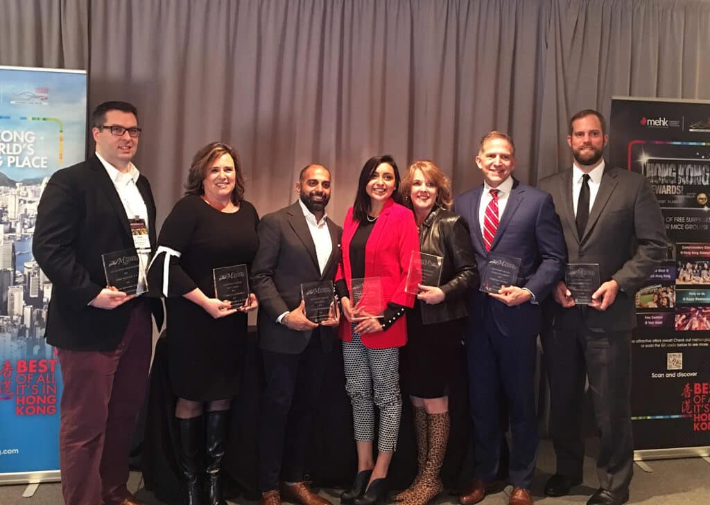 Brightspot employees holding awards