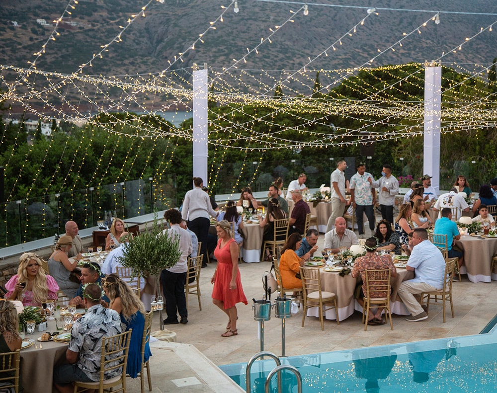 People enjoying a poolside event outdoors