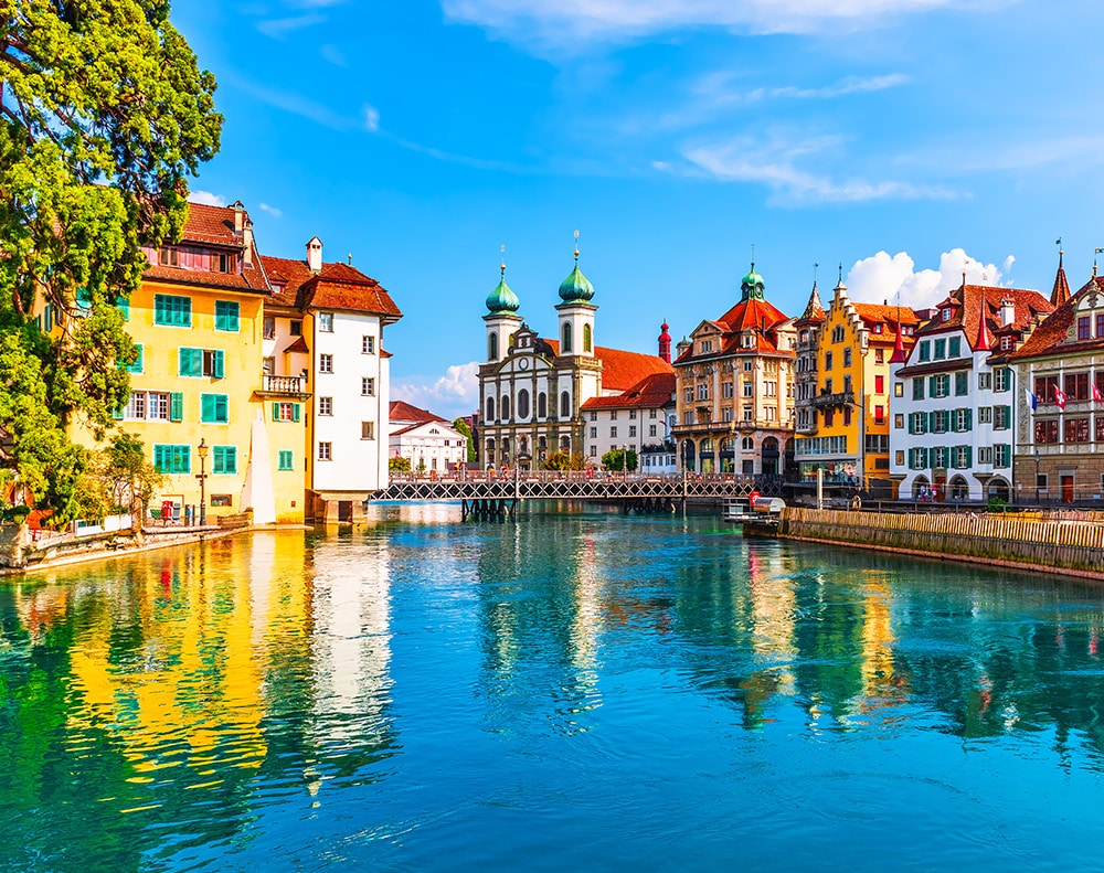 The Reuss River in Lucerne, Switzerland surrounded by brightly colored buildings