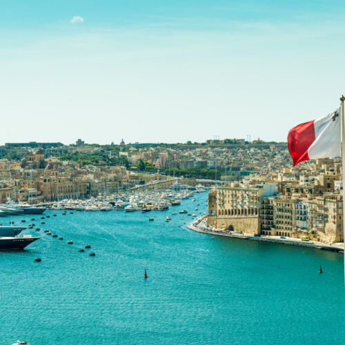 panoramic view on Valletta with the flag of Malta in the foreground