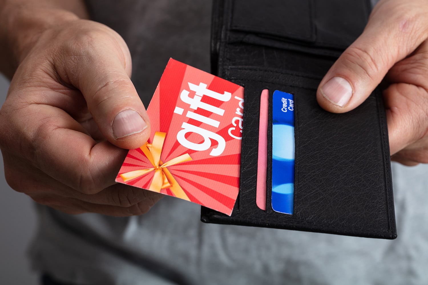 Man pulling a gift card out of his wallet