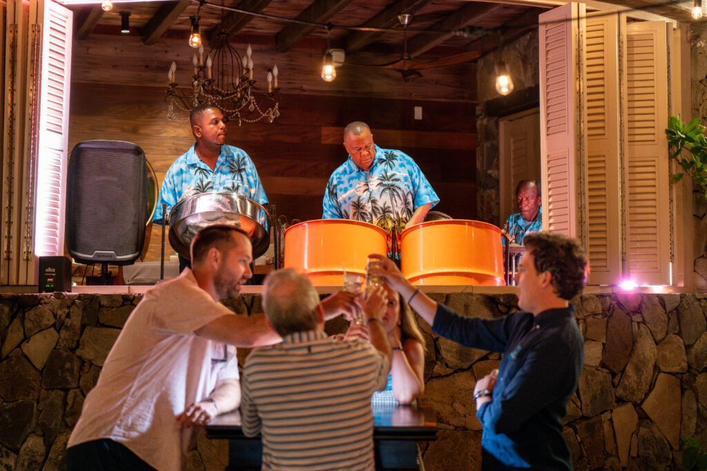 group-of-people-cheering-as-steelpan-drummers-play-in-Virgin-Gorda