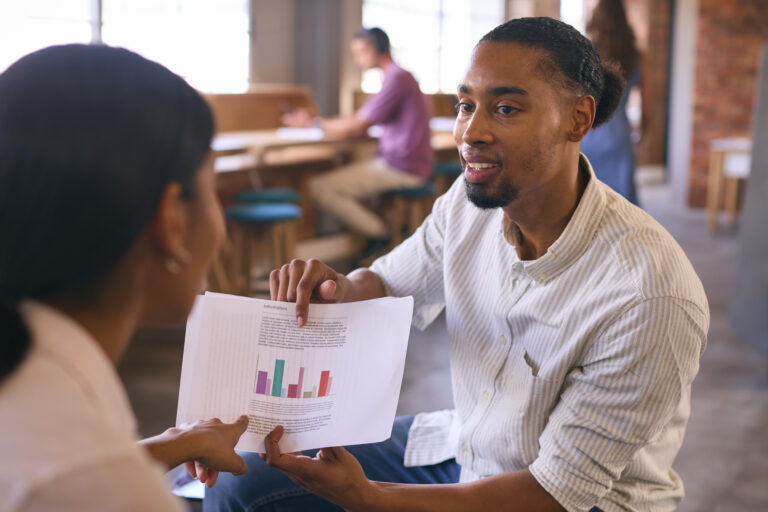 male-and-female-businesspeople-discussing-feedback-from-corporate-meeting