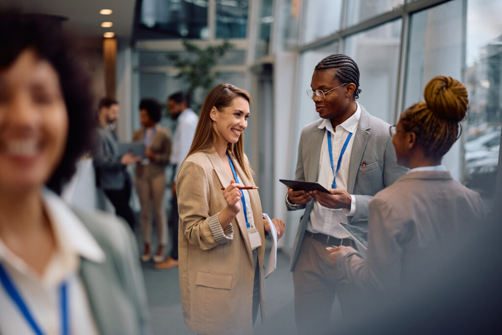Group of business people talking in hallway of an office building